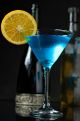 A GLASS OF DINK CURAÇAU BLUE DECORATED WITH ORANGE