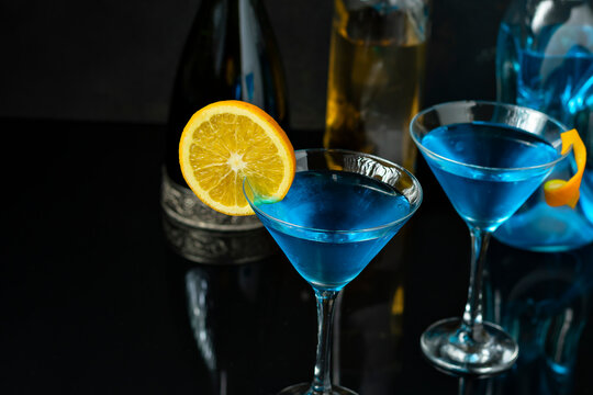 TWO GLASSES WITH DINK CURAÇAU BLUE DECORATED WITH ORANGE