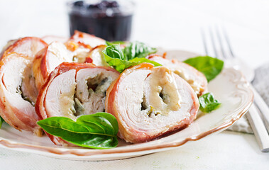 Baked chicken rolls with basil and cheese on  plate. Healthy lunch. Keto diet.