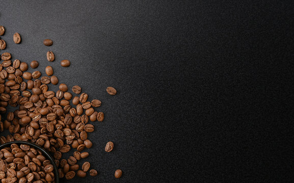 Fresh Raw Organic Coffee Beans On Black.