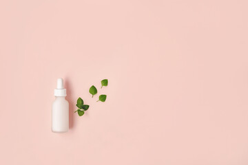 Beautiful composition of white mockup serum bottle and fresh green leaves on pink background. Creative trendy cosmetics flat lay with copy space. Natural cosmetics concept.