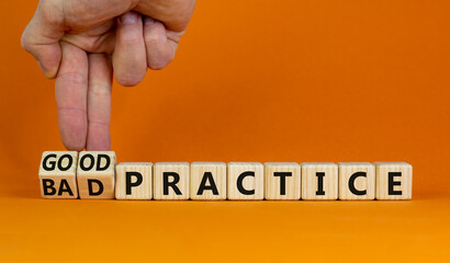 Good or bad practice symbol. Businessman turns wooden cubes and changes words 'bad practice' to 'good practice'. Beautiful orange background. Business, good or bad practice concept. Copy space.