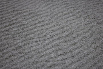 texture with gray sand on a river beach