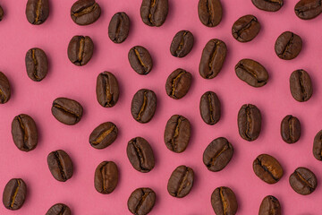 Coffee bean close up macro flat lay on a vibrant pink background 