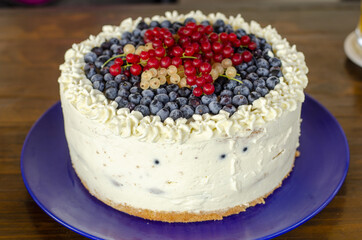 sweet cream cake dessert with currants on the plate