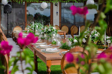 Wedding preparation restaurant and wedding planners.Chairs and honeymooners table decorated with candles, served with cutlery and crockery and covered with a table cloth. wedding area, party area