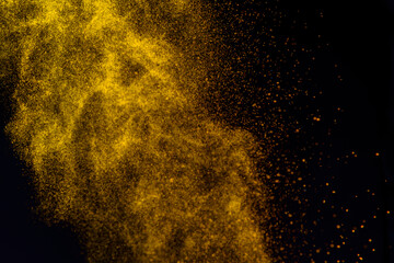 Fototapeta na wymiar Gold glitter stardust trail on black background. Christmas golden spark border with space. Luxury new year holiday party bokeh splash design.