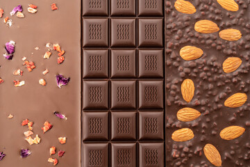assortment chocolate bars with almonds, raspberries, handmade sweets. Composition of bars milk and dark almond chocolate, raspberries on a black background, top view. Pastry craft on the table