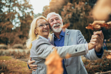 Happy senior couple in autumn park