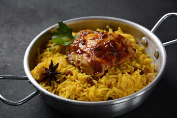 The national Saudi Arabian dish chicken kabsa with roasted chicken quarter and almonds, raisins, garlic and biryani rice