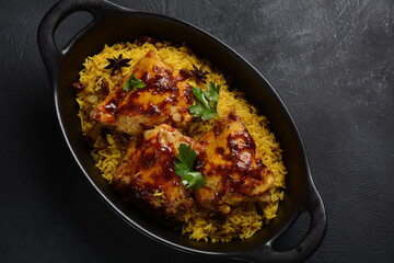 The national Saudi Arabian dish chicken kabsa with roasted chicken quarter and almonds, raisins, garlic and biryani rice