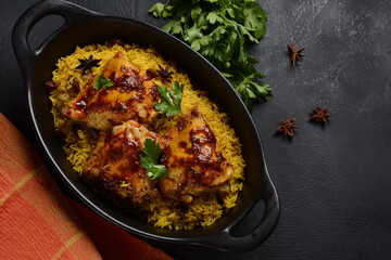 The national Saudi Arabian dish chicken kabsa with roasted chicken quarter and almonds, raisins,...