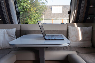 laptop computer ready to internet from inside a caravan