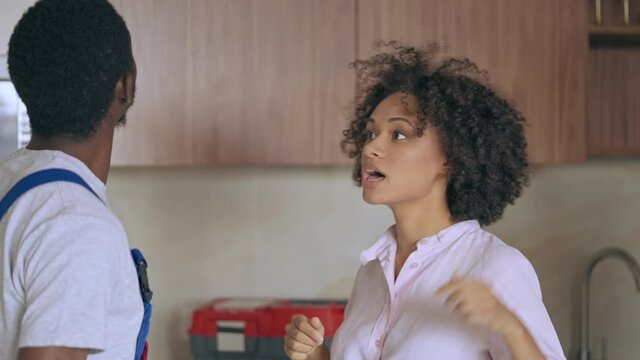 Worker talking to female at home, landlord helping out tenant with problem