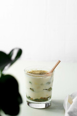 Matcha green tea tiramisù in a glass. White background