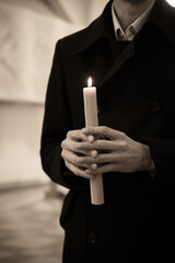 the man holds a candle in his hand