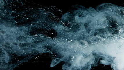 Beautiful wallpaper for your desktop. White cloud of ink on a black background. Drops of white ink...