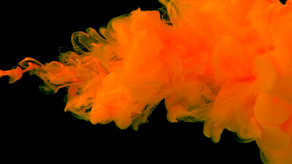Desktop wallpaper. Yellow cloud of ink on a black background. Awesome abstract background.