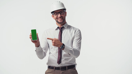 Cheerful engineer pointing at smartphone with chroma key isolated on white