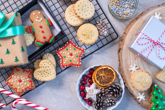 Overhead view of Christmas cookies and biscuits, and Christmas ornaments.