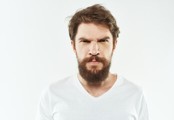 bearded man emotions anger discontent light background