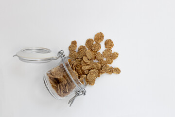 grain flakes in jar isolated on white background