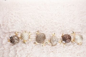 Golden christmas balls with wool background.