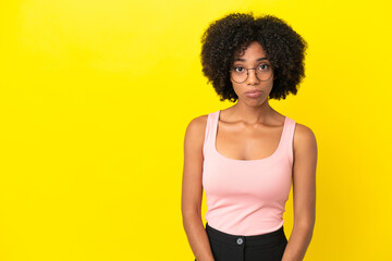 Fototapeta na wymiar Young African American woman isolated on yellow background with sad expression