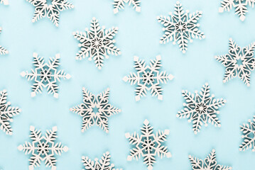 Christmas background. White snow decorations on a pink background.