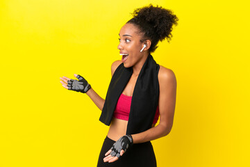 Young African sport woman isolated on yellow background with surprise facial expression