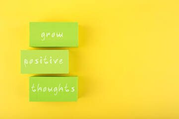 Positive affirmation, mental health or quote concept. Grow positive thoughts written on green...
