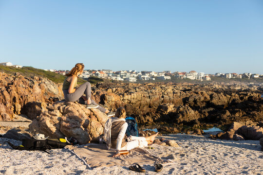 Family on the beach at sunset at De Kelders, a mother and teenage daughter.