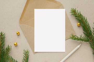 Vertical A6 size note card, invitation or greeting card mockup, brown envelope, Christmas decorations.
