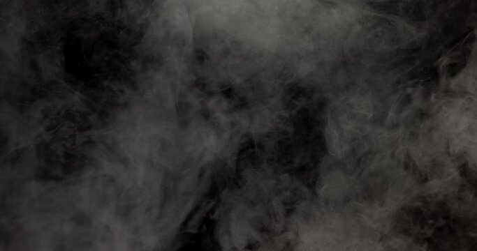 White smoke slowly moving on a black background.
