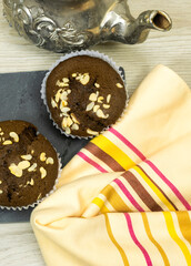Obraz na płótnie Canvas blackboard chocolate nuts muffins, Arabic teapot on wood table