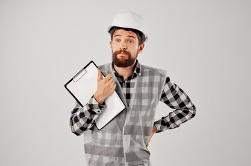 engineer with documents and drawings blueprints light background