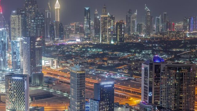 Rows of skyscrapers in financial district and business bay in Dubai aerial night timelapse.