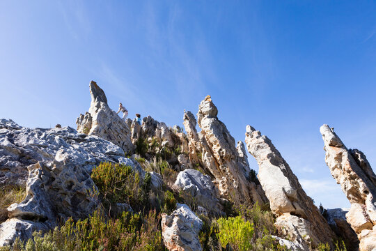 Tall sandstone rock formations on a nature trail.