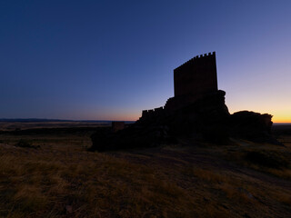 Obraz premium Silhouette of Zafra castle at sunset, Spain