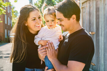 Obraz premium Young family with cute two years old child outside