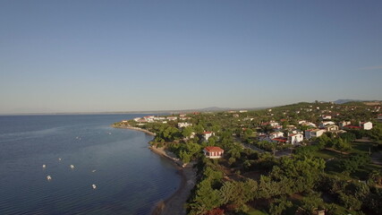 Fototapeta na wymiar Coastal town scene with blue sea Aerial view of Trikorfo Beach, Greece