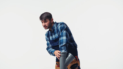 Plumber in uniform holding plastic pipe isolated on white