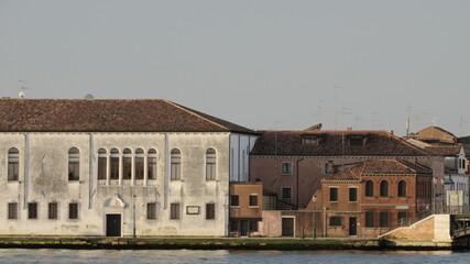 Fototapeta na wymiar Houses by water in Venice, Italy, View from sailing boat