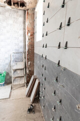 detail of tiles placed in the bathroom with a separator between them while the cement dries to maintain the separation