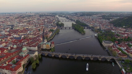Obraz premium Flying over Vltava river with Charles Bridge in Prague
