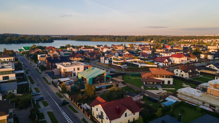 Fototapeta na wymiar Aerialphoto suburbs of big city. Country houses, forests, lakeshore. Citylife concept.