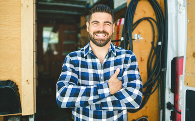 Portrait of an electrician happy worker at work