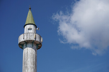 Fototapeta na wymiar white wooden mosque minaret