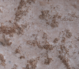The surface of the pink granite mineral with inclusions