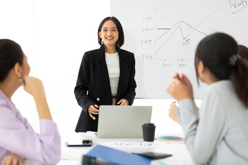 young businesswoman seminar or meeting and presentation about work project on whiteboard